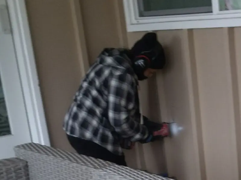 Professional electrician installing an exterior outlet in Sidney